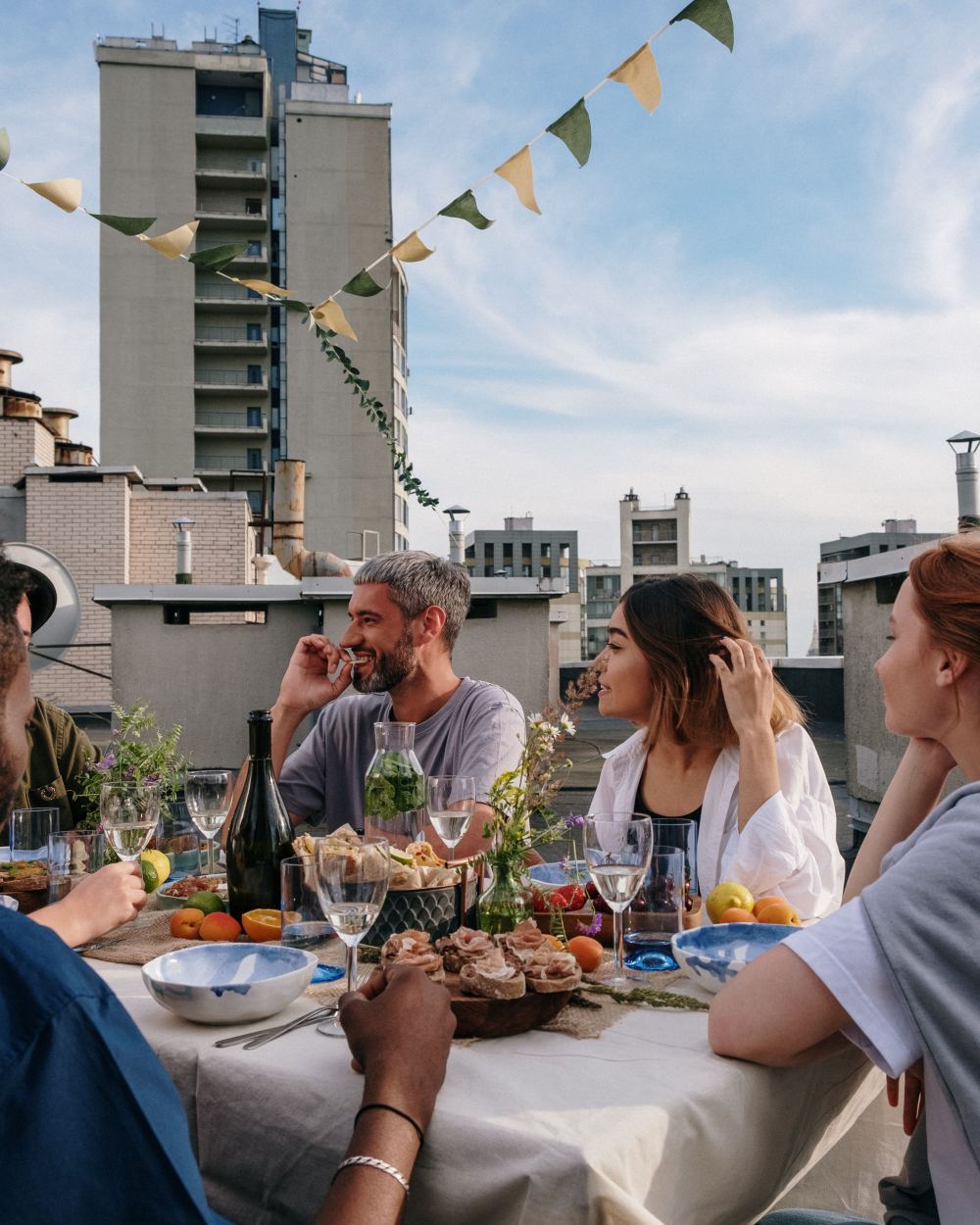 A laid table on a roof terrace above the city